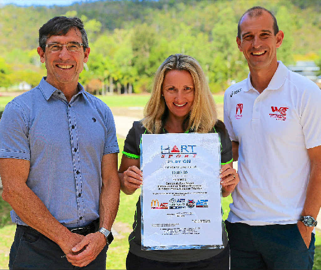 COMPETITION: Mike Muller (McDonald’s), Annette Munckton (Head of PE Cannonvale State School) and Stephen Jackson (Whitsunday Triathlon Club) with the award for last year’s winners.